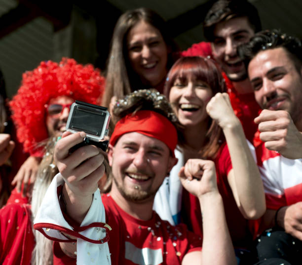 istock Group of Fans Taking a Video 967994066