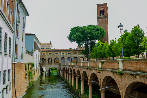 MANTUA, LOMBARDY, ITALY - May 23, 2018: Panorama of the area called Le Pescherie and the waterway   Rio, in the background stands the bell tower of San Domenico.