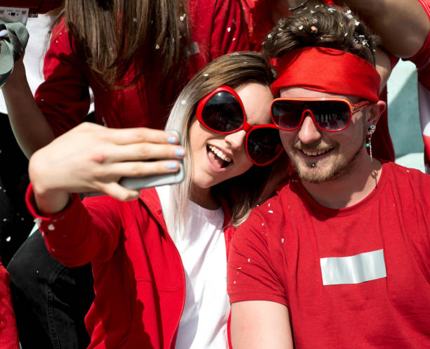 istock Group of Fans Taking a Selfie 968003418