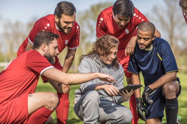 istock A soccer team looking at tactics on a tablet during a football training session 968008954