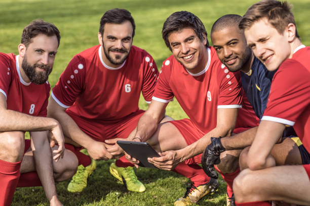 istock A soccer team looking at tactics on a tablet during a football training session 968008984