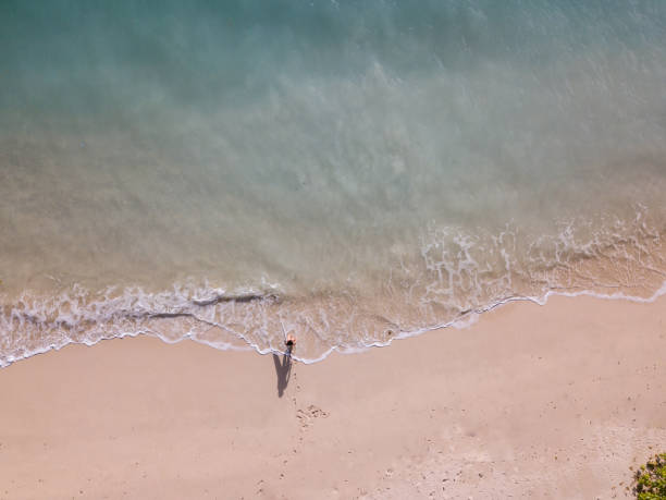 istock Surfer woman going into the water 968009152