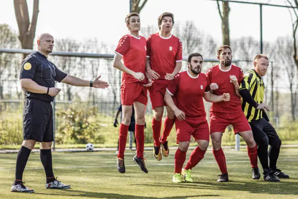 A soccer referee controlling the situation during a football match