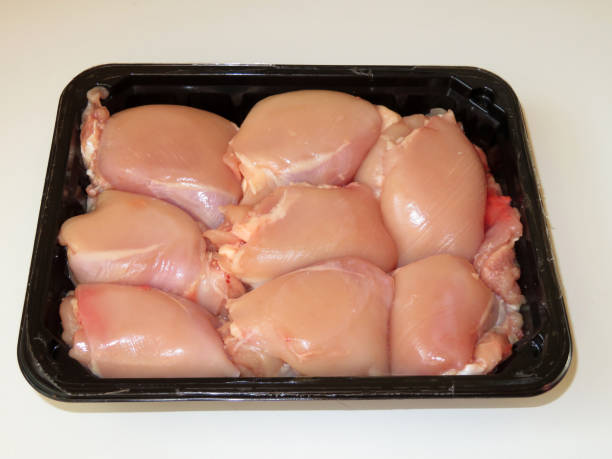 istock Open package of raw chicken thighs without skin 968011802