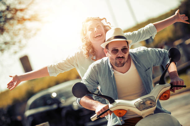 istock Cheerful couple riding scooter 968014424