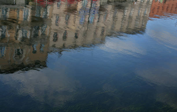 istock Reflection of buildings in water 968014744