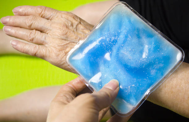 istock Old woman with ice pack for muscle aches 968059876
