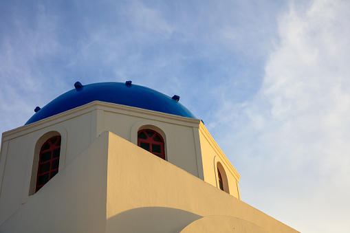 Santorini, Greece - White church with blue dome on sky background