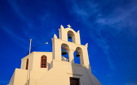 Santorini, Greece - White church with blue dome on sky background
