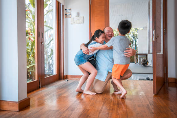 istock Father hugging his children when coming home 968062612