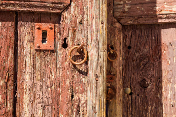 istock Rusty metal lock on an old wooden door 968065092