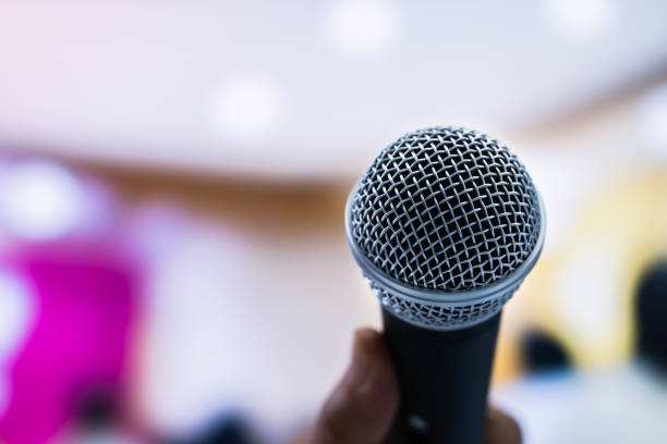 istock Microphones on abstract blurred of speech in seminar room or front speaking conference hall, blure light people in event meeting convention hall background, close up shot for copy space, Vintage tone 968067558