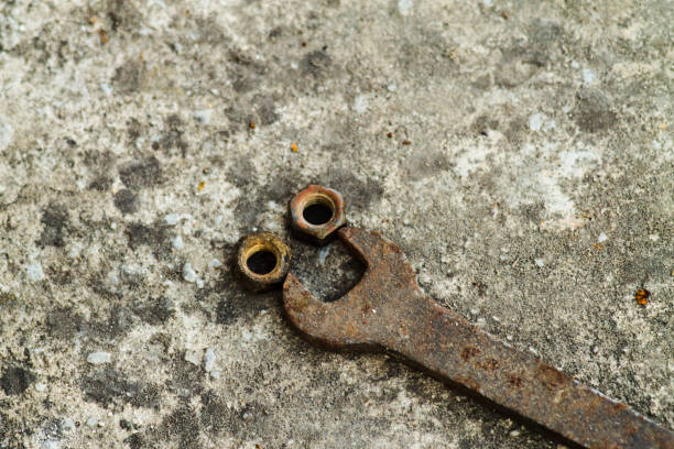 istock Metal nut and key in the garage. Rusty old wrench 968080902