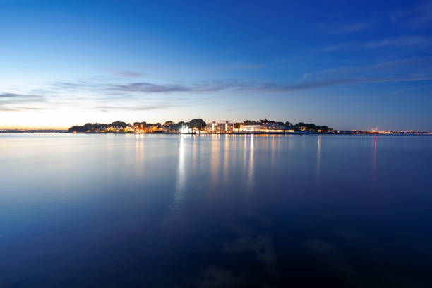 Sandbanks in Dorset at night Sandbanks peninsular and Poole Harbour on the UK's south coast at night sandbanks poole harbour stock pictures, royalty-free photos & images