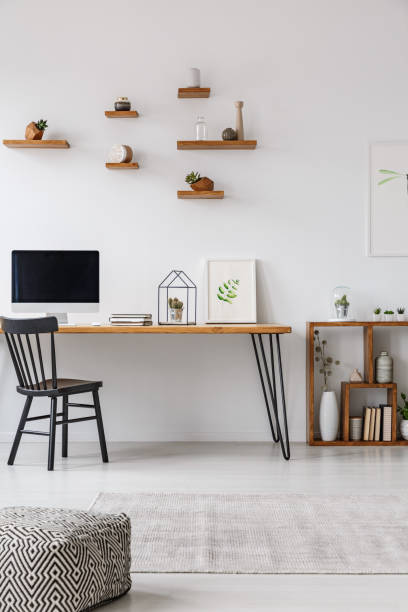 istock Patterned pouf in minimal workspace interior with black chair at table with computer monitor. Real photo 968086578