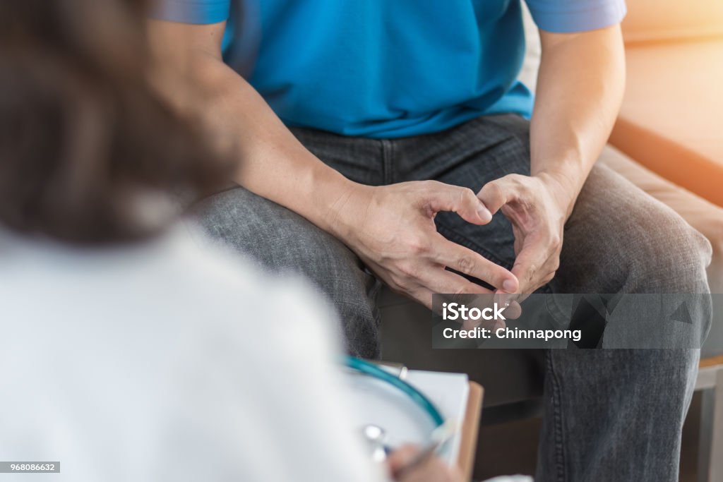 Male patient having consultation with doctor or psychiatrist who working on diagnostic examination on men's health disease or mental illness in medical clinic or hospital mental health service center Prostate Cancer Stock Photo