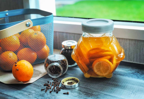 still life orange in a jar, basket near window on a wooden table