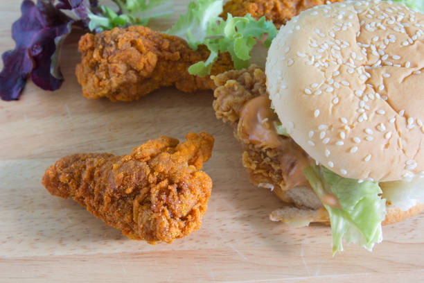 istock Hamburger with fried chicken on wooden plate 968126296