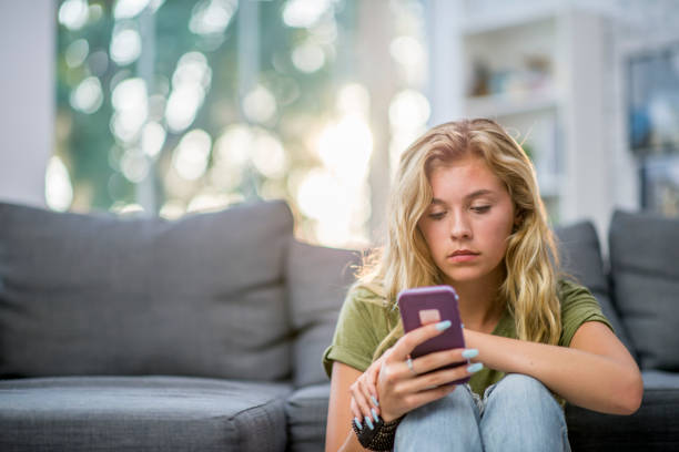 istock Lonely Girl Looking At Phone 968156010