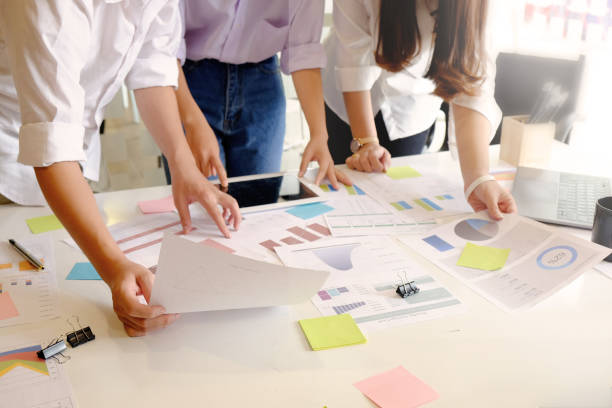 istock Top view Business brainstorming meeting with tablet computer and paper document chart investment finance. 968173716