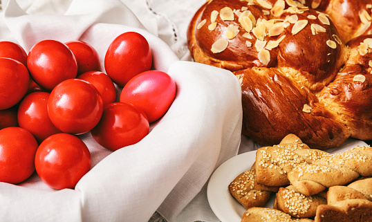 Easter traditional bread and red eggs on a table