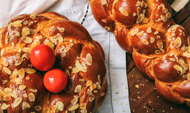 Easter traditional bread Easter traditional bread and red eggs on a table -  top view easter cake stock pictures, royalty-free photos & images