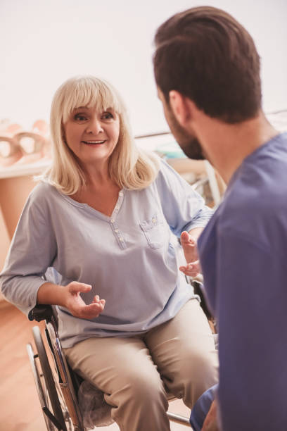 istock Old woman and doctor 968194560