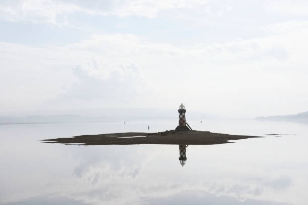 istock lighthouse silhouette port harbor harbour island ocean bright light warning protection sea ships boats fisherman port glasgow greenock Scotland uk 968201680