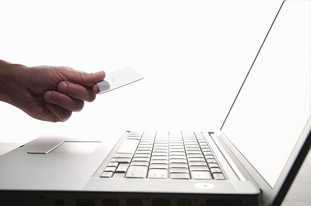 istock Hand holding credit card, working on laptop 96820642