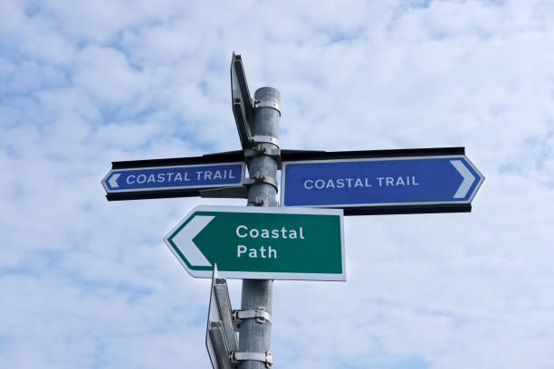 istock Coastal walk path direction trail trek sign directional for walkers outdoors hiking rambling signpost against blue sky and clouds uk 968214204