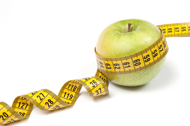 istock Green Apple with measuring tape, isolated on white 96822398