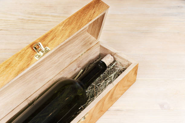 istock Dark bottle of wine within wood box 968229056