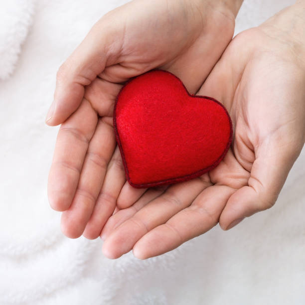 istock Red heart in male hands 968229162