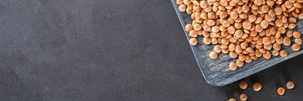 istock Raw red lentils on a wooden board. Superfood. 968251464