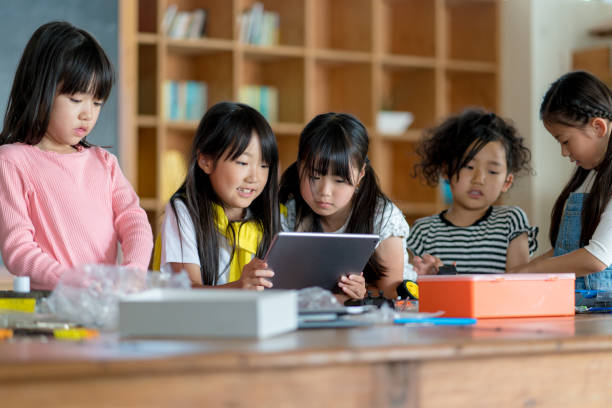 istock Young group of students in a robotics club having fun 968253854