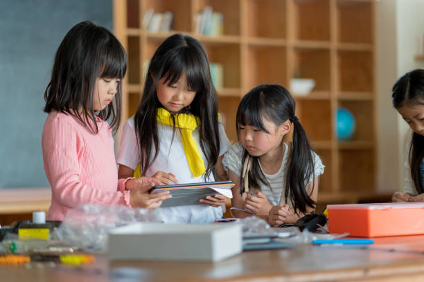 istock Young group of students looking at a digital tablet 968253858