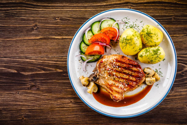 istock Grilled pork chop and vegetables 968254034