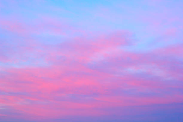 istock bright pink clouds on a blue sky at the sunset 968257592