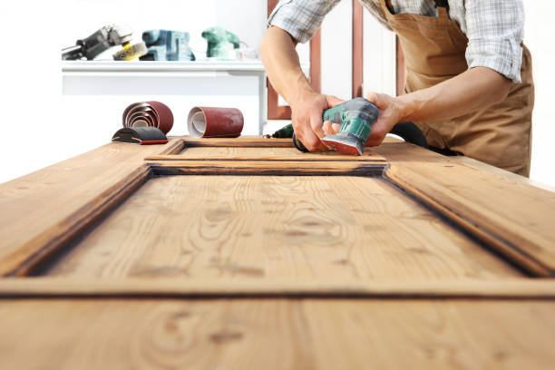istock carpenter work the wood with the sander 968260124