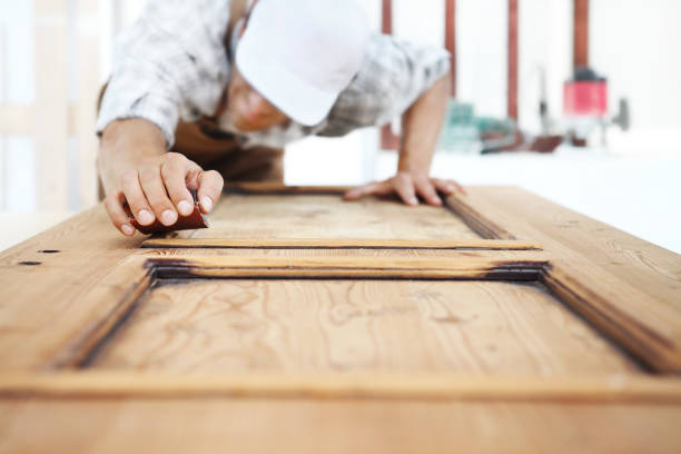 istock carpenter work the wood with the sandpaper 968260154