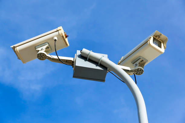 istock Surveillance CCTV camera against the blue sky 968264342
