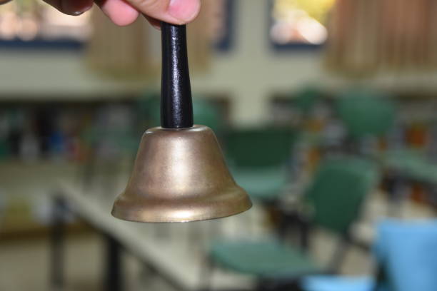 istock A hand holding a bell in a school 968266828