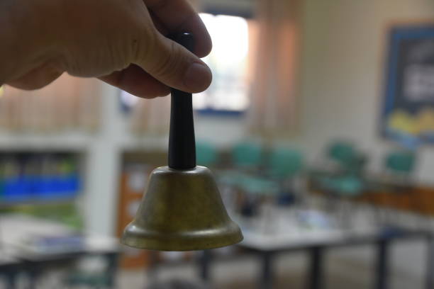 istock A hand holding a bell in a school 968266898