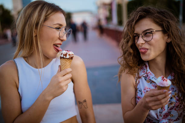 istock Beautiful women eating ice cream in walk 968269676