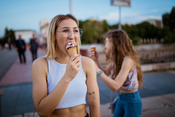istock Beautiful women eating ice cream in walk 968269678