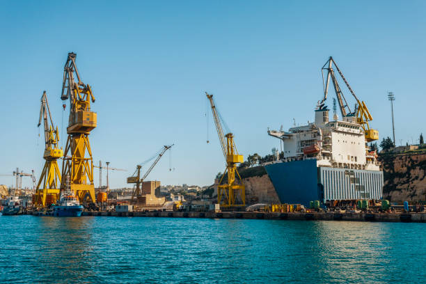 A cargo ship full of containers stands for loading or unloading goods.
