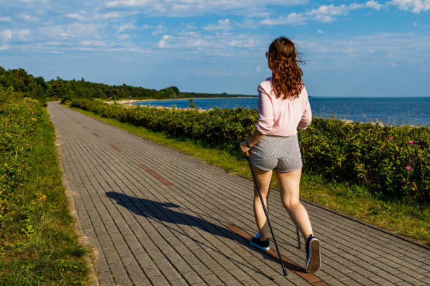 Nordic walking - woman training at seaside