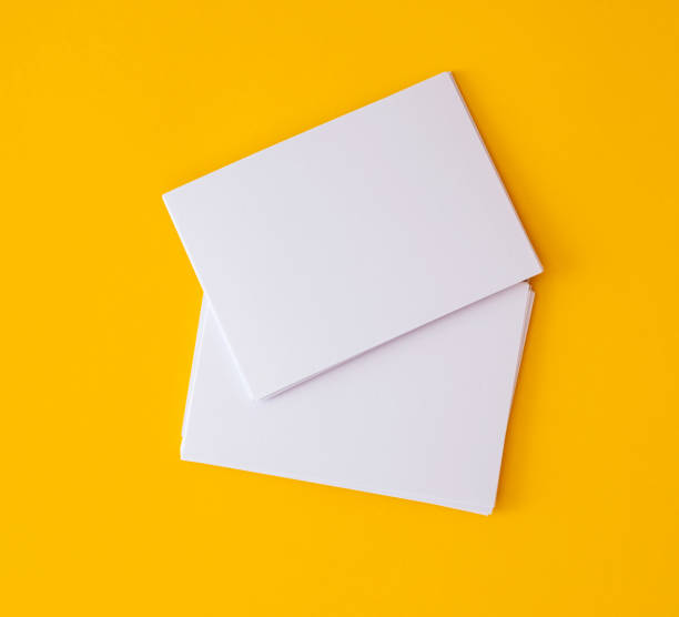 stacking of mockup empty white business card   on vibrant yellow background , template for business  branding  design