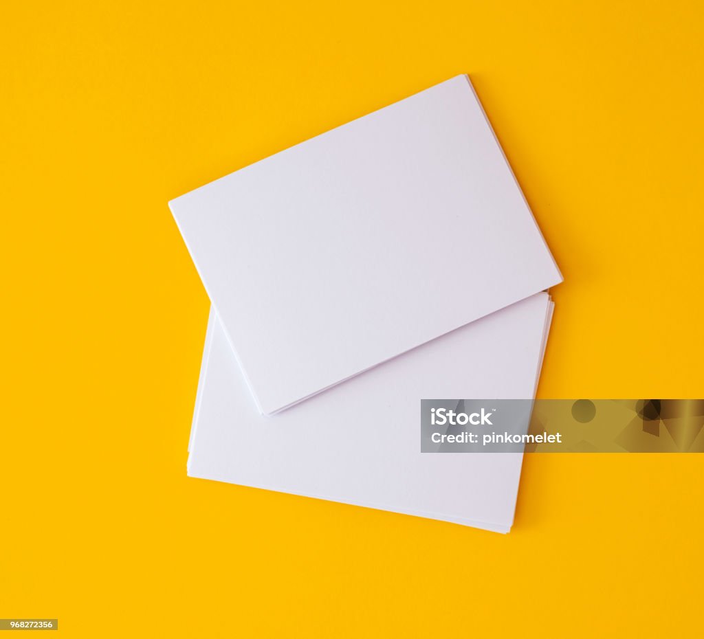 stacking of mockup empty white business card   on vibrant yellow background , template for business  branding  design a stacking of mockup empty white business card   on vibrant yellow background , template for business  branding  design Postcard Stock Photo