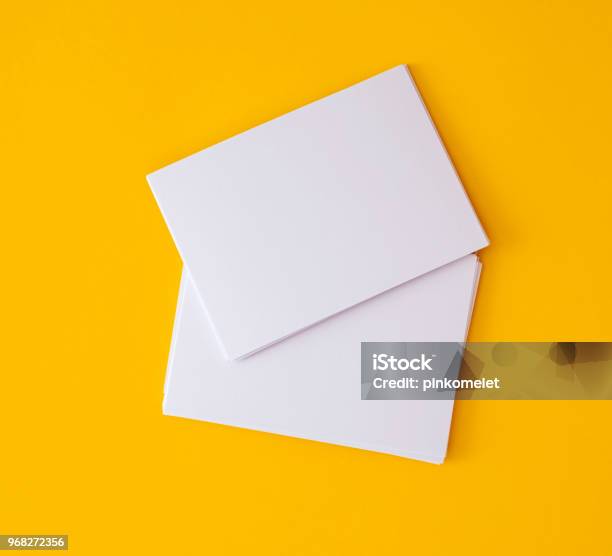 Stacking Of Mockup Empty White Business Card On Vibrant Yellow Background Template For Business Branding Design Stock Photo - Download Image Now